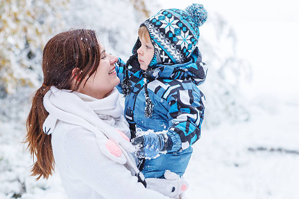 istock Little preschool boy and his mother playing with first snow 466875207