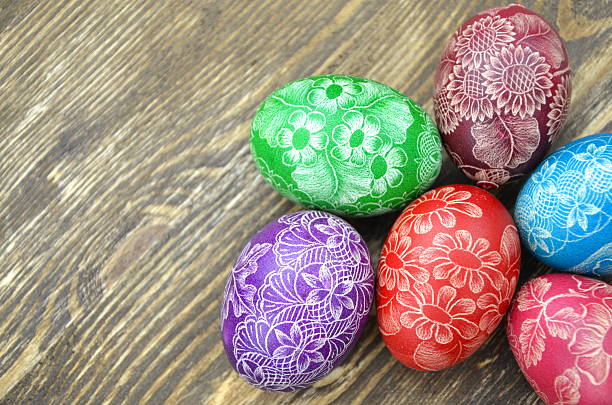 istock colorful scratched handmade Easter eggs on wooden table 466876314