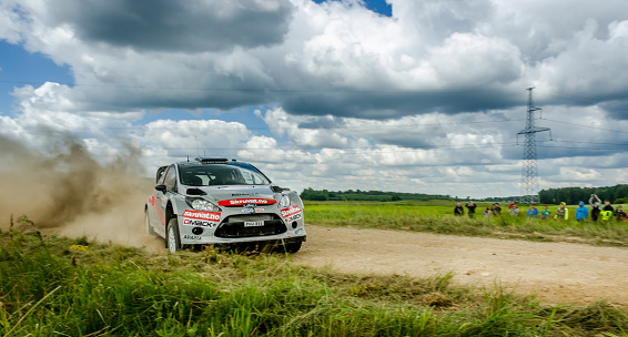 Druskininkai, Lithuania - June 27, 2014: WRC Rally car going sideways on gravel in Lithuania. Car drivern by Henning Solberg during Rally Poland 2014