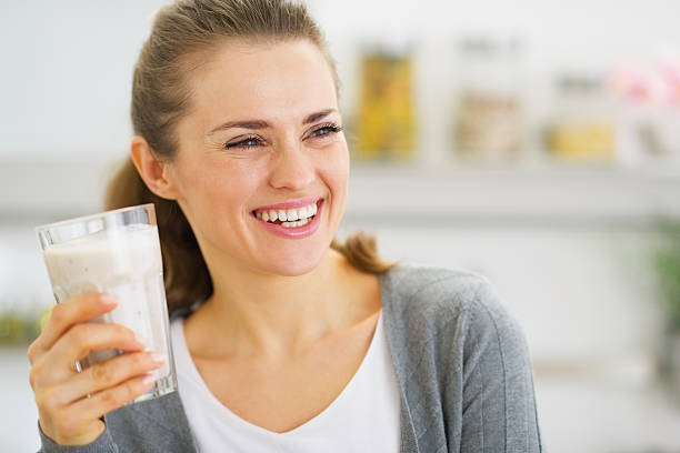 smiling young woman drinking fresh cocktail Smiling young woman drinking fresh cocktail milkshake stock pictures, royalty-free photos & images