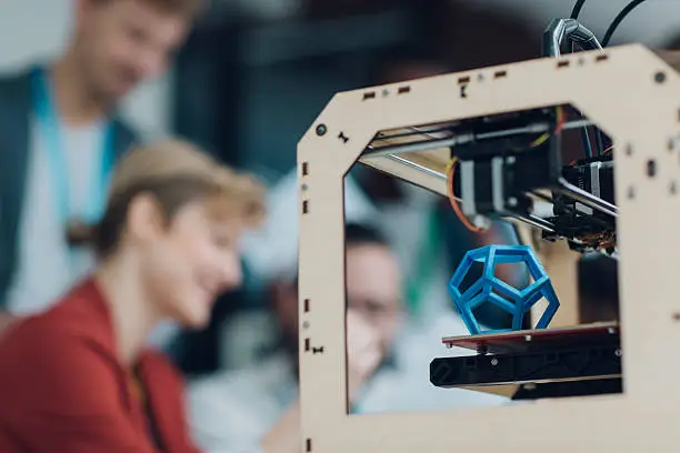 Photo of Creative Start-Up Business Team Working by 3D Printer.