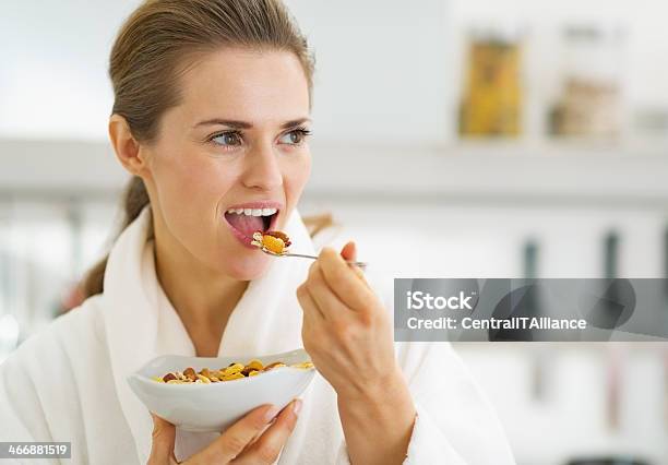 Young Housewife Having Healthy Breakfast In Kitchen Stock Photo - Download Image Now