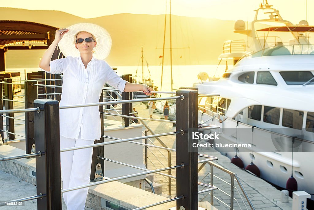 Lady at Boat Dock Attractive woman near the yachts. Adult Stock Photo