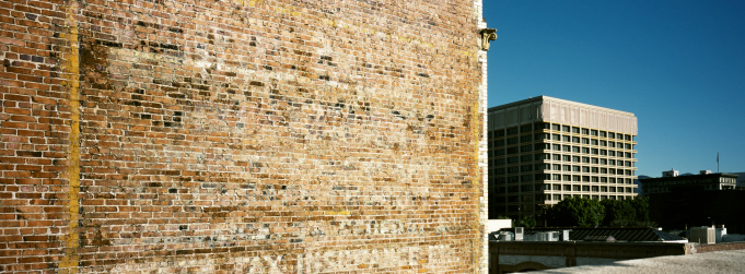 Corner of a 1920s brick building and 1970s California Architecture at a distance. The photo is taken with a panoramic camera (Hasselbad XPAN), 45mm lens. Image is slightly cross-processed.