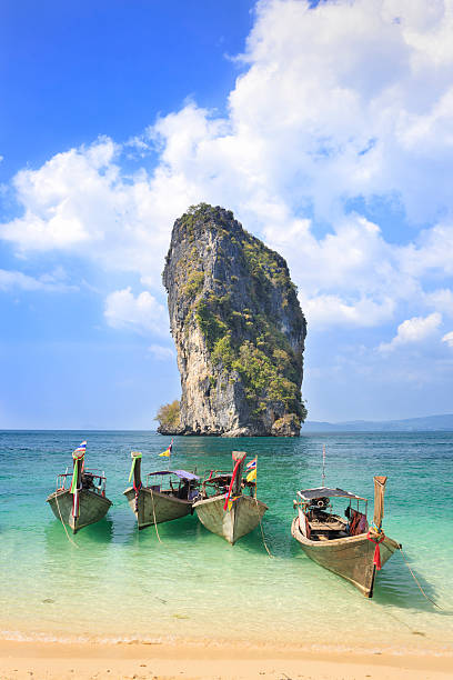 Thai longtail boats on Poda Island, Thailand Typical Thai longtail boats Poda Island, Thailand. The longtail boats are used as water taxis to bring tourists to remote beaches or islands. koh poda stock pictures, royalty-free photos & images