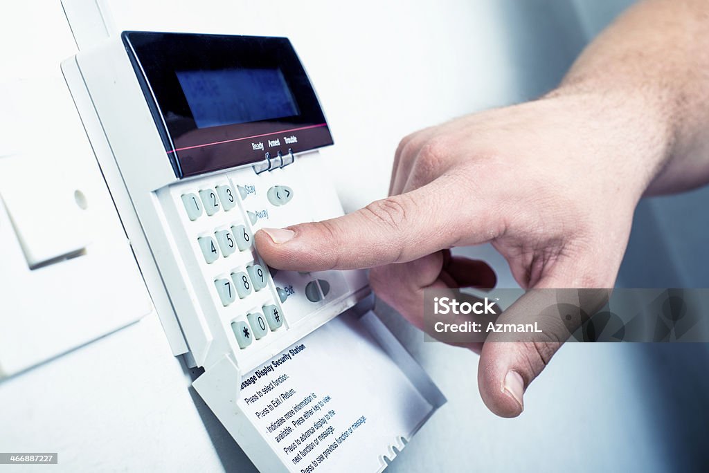 Typing security code Typing security code on alarm keybord, to turn it off. Burglar Alarm Stock Photo