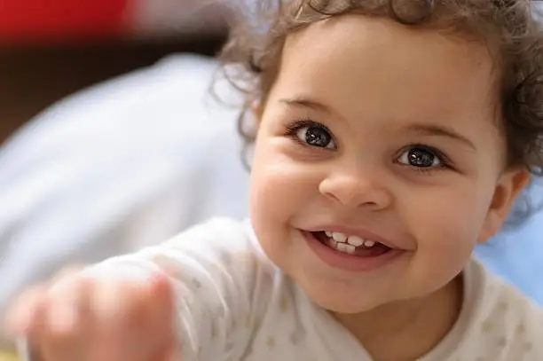 Royalty free stock photo of 2 years old baby girl headshot. This file has a signed model release. Shot in RAW, post processed in Prophoto RGB, no sharpening applied.