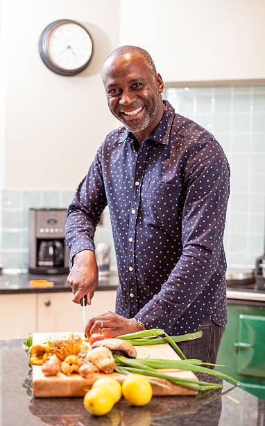 istock Happy man preparing food in the kitchen 466889373