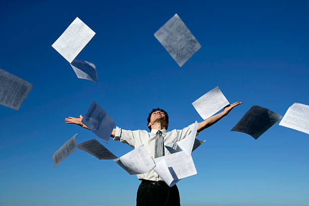 istock Businessman throwing papers into the air 466889951