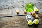 Glass of absinthe with lime and sugar cubes