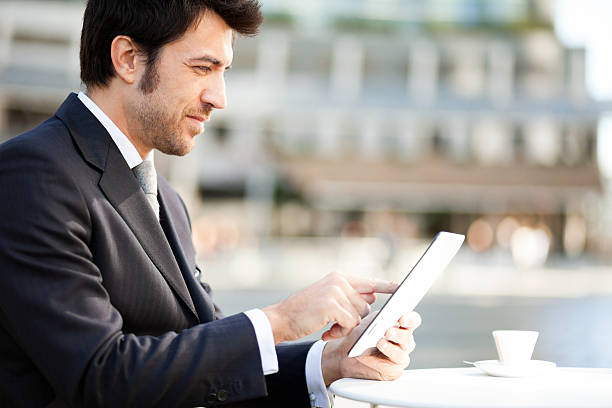 istock Businessman reading his digital tablet 466899576