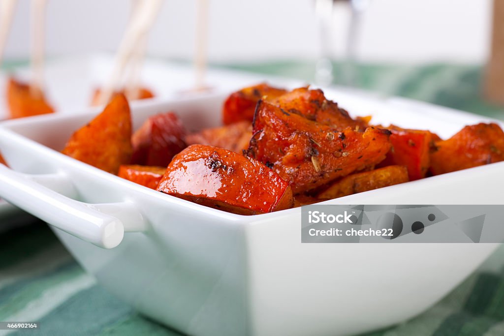 Roasted Pumpkin in Bowl Pumpkin roasted with herbs and spices and served as appetizers. 2015 Stock Photo