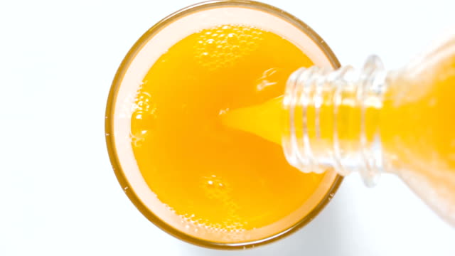 Glass of orange juice top view.