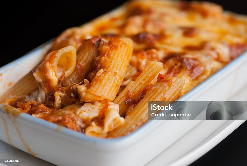 Baked penne pasta with tomato sauce and cheese Baked penne pasta with tomato sauce and cheese in White bowl Rigatoni Stock Photo