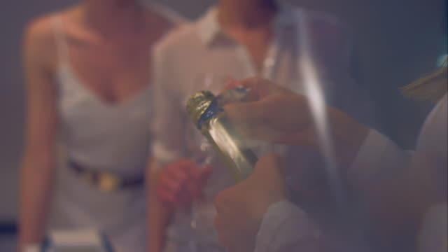 Woman opening sparkling wine