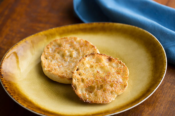 English Muffin English Muffin on a Plate with Blue Napkin english muffin stock pictures, royalty-free photos & images