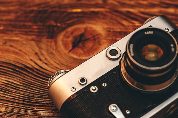 istock Vintage camera on wooden background 466907128
