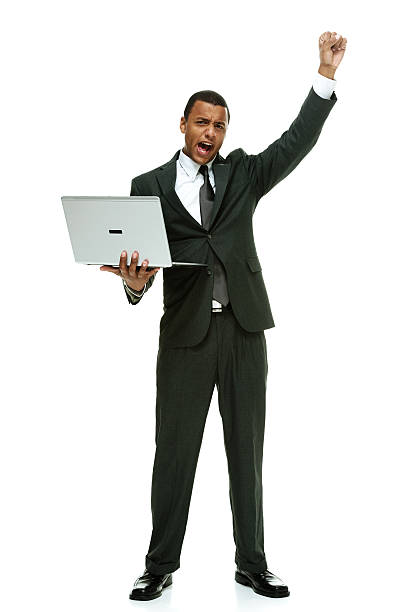 istock Businessman cheering and holding laptop 466914934
