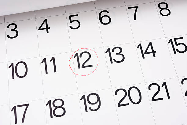 istock Setting a date in a red round mark on calendar 466920346