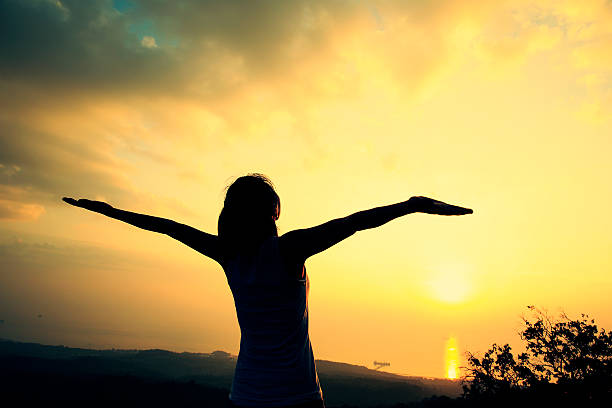 istock cheering woman on mountain peak 466921002