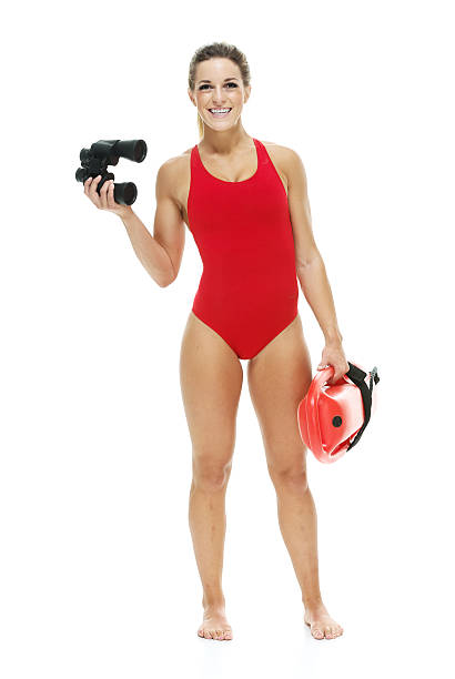 istock Female lifeguard with life buoy and binoculars 466922322