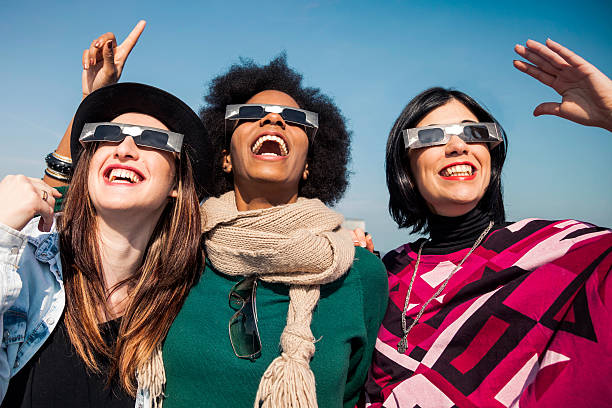 istock Group of friends looking to a solar eclipse 466925234