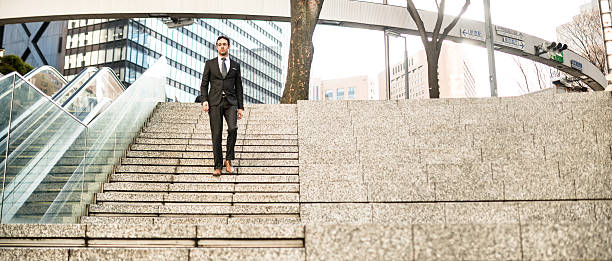 istock business man descending the steps on wall street 466929402
