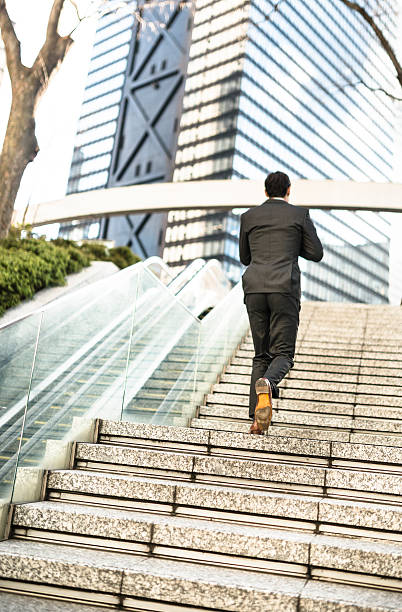 istock business man moving up the steps 466929404