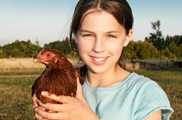 istock Girl Holding Hen 466930963