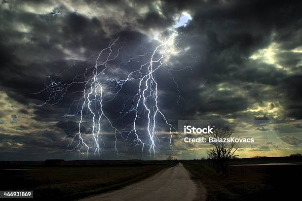 Asphalt Road And Dark Stormy Clouds Over It Stock Photo - Download Image Now - Agricultural Field, Asphalt, Atmospheric Mood