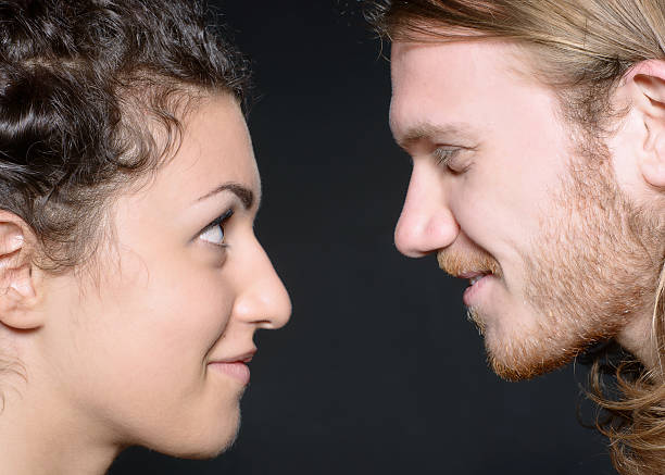 istock Boy and girl in profile look intensely at each other 466931895