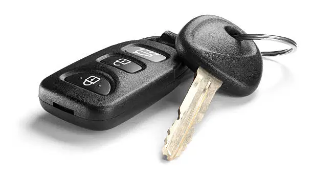 Photo of Black car key and remote on white background