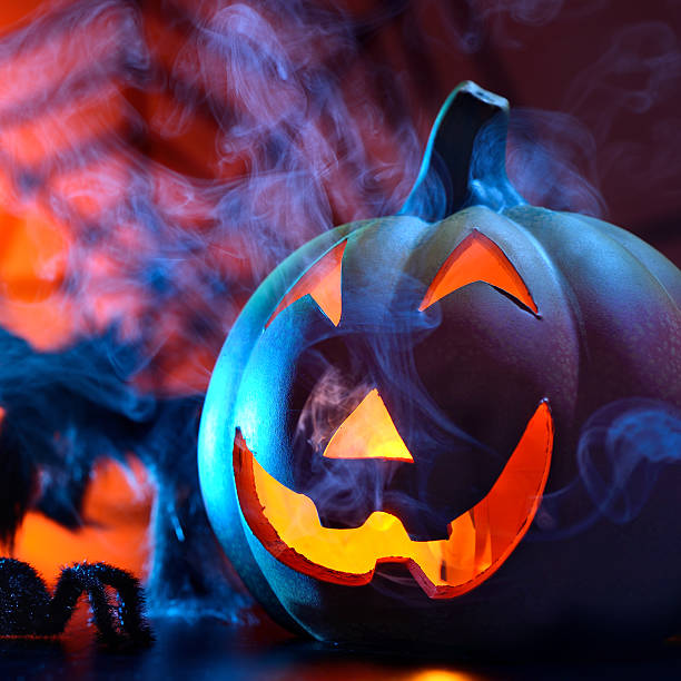 istock Halloween pumpkin in dark blue with spider web and smoke 466935299