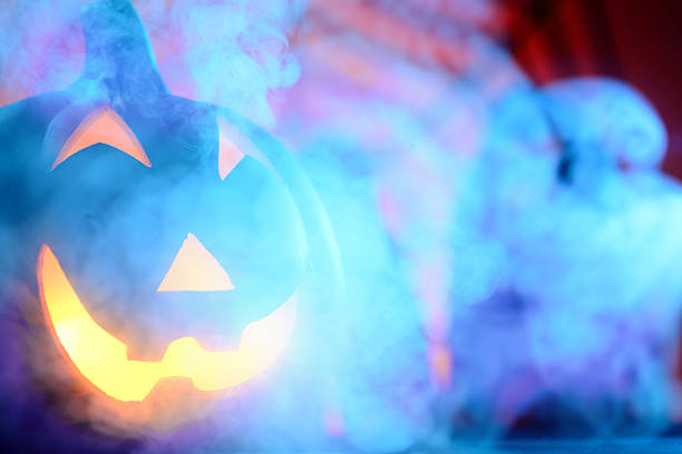 istock Halloween pumpkin in dark blue with spider web and smoke 466935319