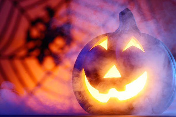 istock Halloween pumpkin in dark blue with spider web and smoke 466935323