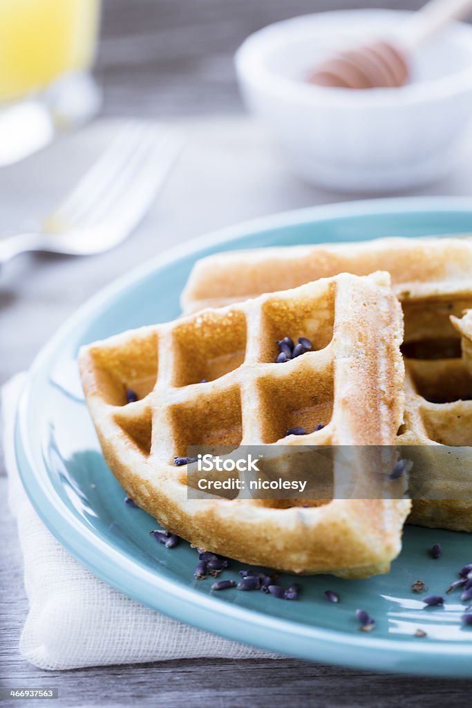 Waffles with Lavender Waffles on a blue plate topped with lavender. Blue Stock Photo