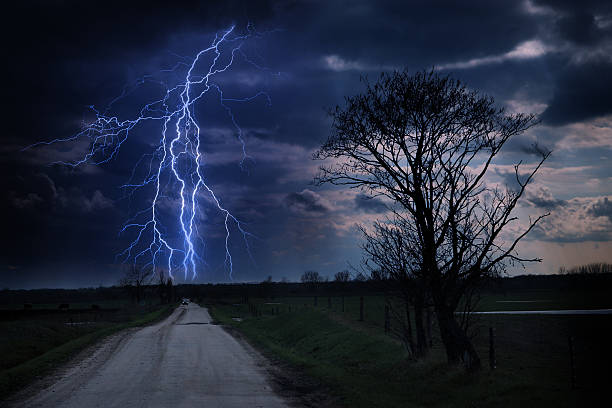 istock Asphalt road and lightning storm at night 466937897