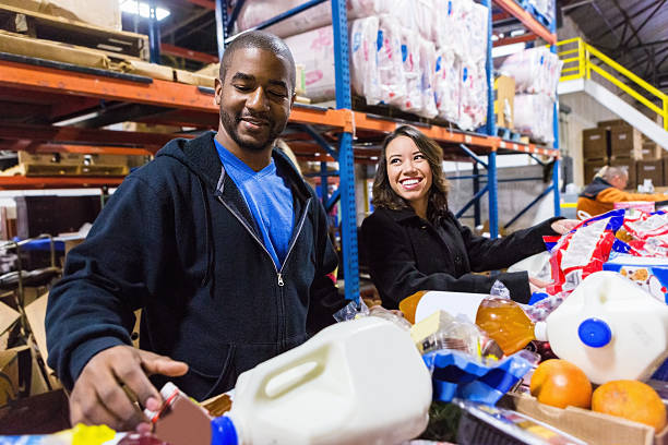 Diverse Volunteers cheerfully sorting food items