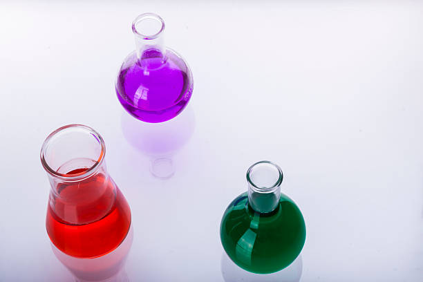 istock Laboratory glassware with liquids of different colors on white background. 466941039