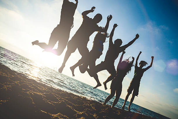istock Group of friends jumping on the beach at dusk 466941122