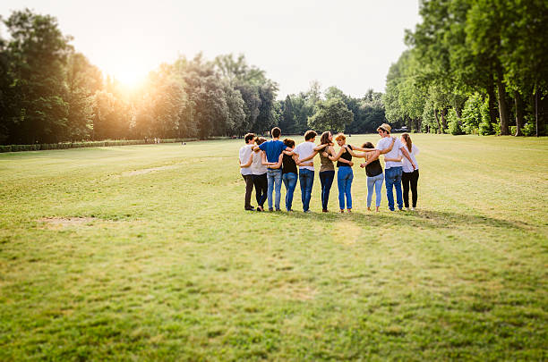 Group Of Friends Walking Together Group Of Friends Walking Together arm in arm stock pictures, royalty-free photos & images