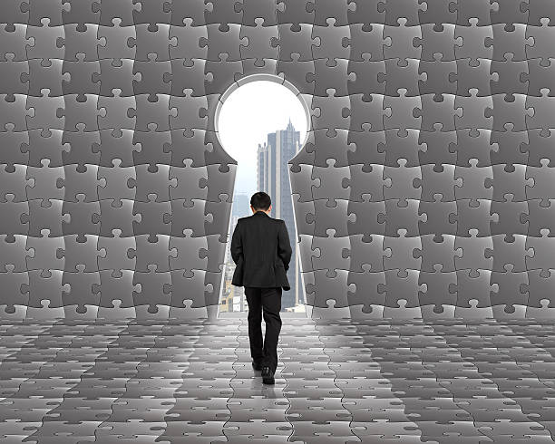 istock Businessman walking toward key shape door with puzzles background 466946761