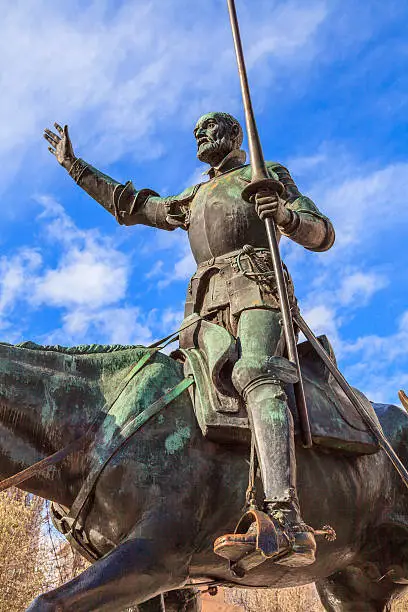 Close shot of the bronze statue of Don Quixote de la Mancha, the literature anti hero of famous writer Miguel de Cervantes. He is riding his horse at the Plaza de España in Madrid, Spain. I was designed by Rafael Martínez Zapatero, Pedro Muguruza and Lorenzo Coullaut Valera. The monument was built between 1925 and 1930, but finished in 1957 by Federico Coullaut-Valera Mendigutia