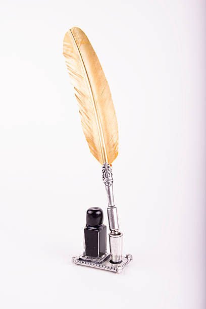 istock golden pen and ink on a white background 466950240