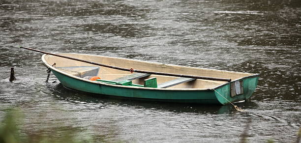 rowboat The fishing boats in the rain longboat key stock pictures, royalty-free photos & images