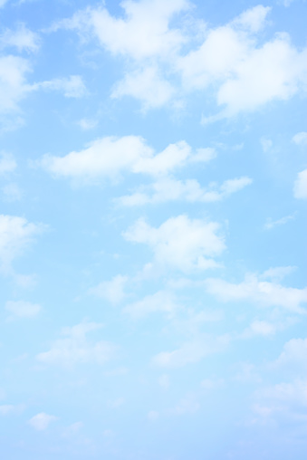 Light blue spring sky with clouds, may be used as background