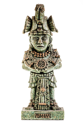 an ancient toltect statuette isolated over a white background