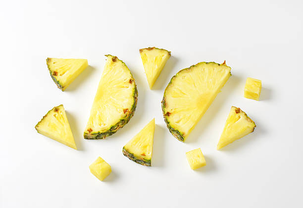 Fresh pineapple slices and wedges stock photo