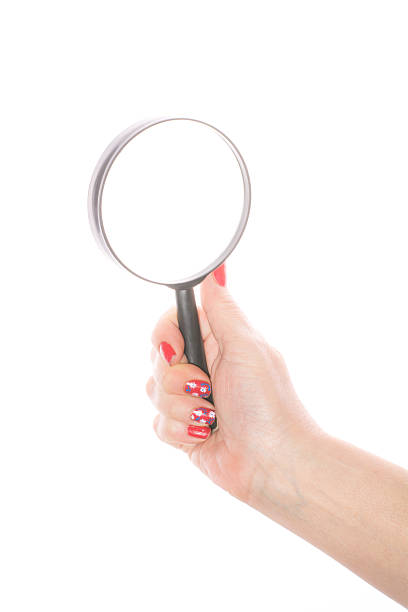 istock Female hand holding magnifying glass on a white background 466953828