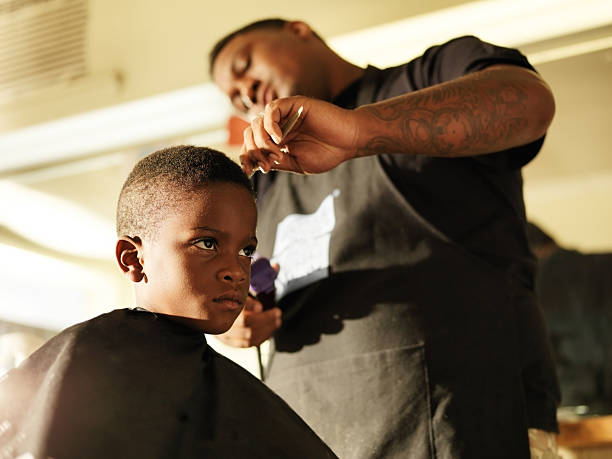 Photo Of A Boy Getting His Hair Cut By A Barber Stock Photo - Download  Image Now - Barber Shop, Barber, African-American Ethnicity - iStock
